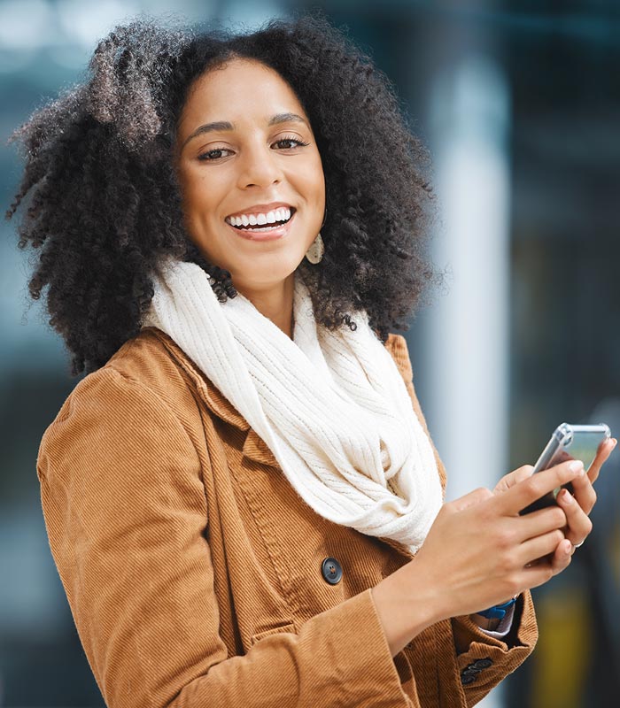 Happy woman using her phone